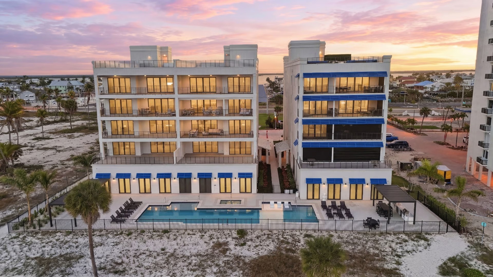 Gulfside Twelve at dusk, impact windows and doors across the Gulf-facing facade